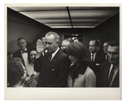 Cecil W. Stoughtons Personal, Unpublished Photo of LBJs Inauguration Aboard Air Force One -- LBJ Takes the Oath of Office as Jackie Stands Witness